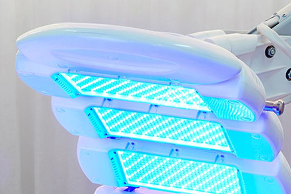 Close-up of Dermalux LED light panels during skin treatment
